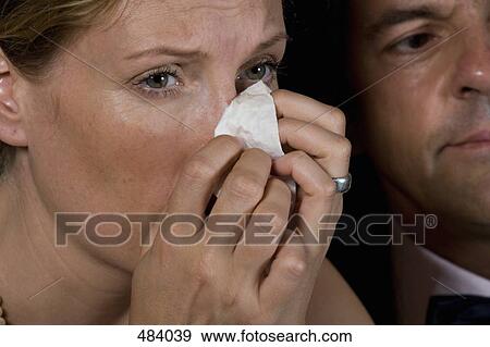 A woman crying whilst sitting with a man in a theater box View Large Photo Image Stock Photo - A woman crying whilst sitting with a man in a theater box. Fotosearch
