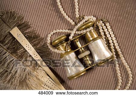 Pearls, binoculars and a feather fan View Large Photo Image Stock Photo - Pearls, binoculars and a feather fan. Fotosearch