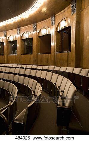 Rows of empty seating in an illuminated art deco theater View Large Photo Image Stock Photography - Rows of empty seating in an illuminated art deco theater. Fotosearch