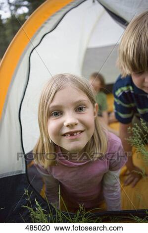 Stock Image - Portrait of a young girl in a tent. Fotosearch