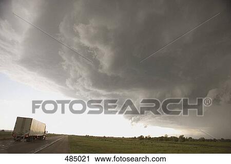 Storm clouds over a rural landscape and a semi-truck on a highway View Large Photo Image Stock Image - Storm clouds over a rural landscape and a semi-truck on a highway. Fotosearch