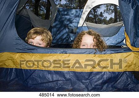 Picture - Two boys hiding in a tent. Fotosearch