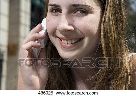 Stock Photography - An adolescent girl using a mobile phone. Fotosearch