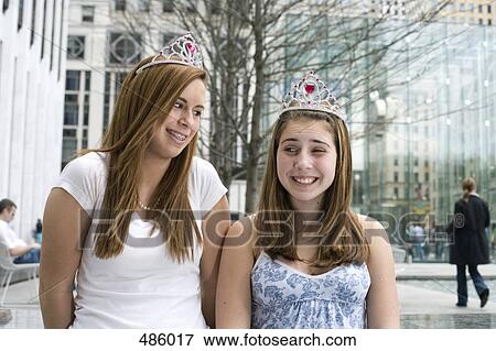 Stock Photo - Two adolescent girls wearing tiaras. Fotosearch