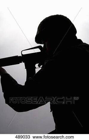 Silhouette of a soldier aiming a gun View Large Photo Image Stock Image - Silhouette of a soldier aiming a gun. Fotosearch
