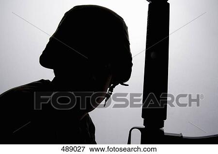 Silhouette of a soldier and his gun View Large Photo Image Stock Photo - Silhouette of a soldier and his gun. Fotosearch