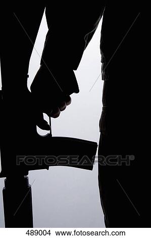 Silhouette of a soldier holding a gun View Large Photo Image Picture - Silhouette of a soldier holding a gun. Fotosearch