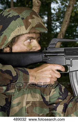 Soldier aiming his gun View Large Photo Image Stock Image - Soldier aiming his gun. Fotosearch