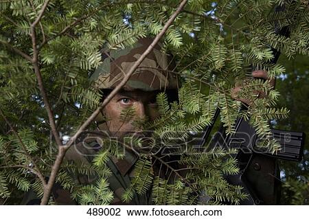 Soldier hiding behind a tree View Large Photo Image Stock Image - Soldier hiding behind a tree. Fotosearch