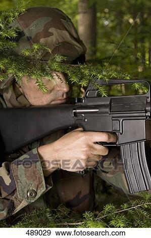 Soldier hiding in a forest View Large Photo Image Stock Photo - Soldier hiding in a forest. Fotosearch