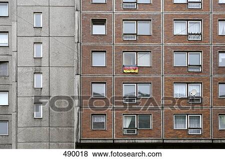 A German flag hanging from the window of an apartment View Large Photo Image Stock Photo - A German flag hanging from the window of an apartment. Fotosearch