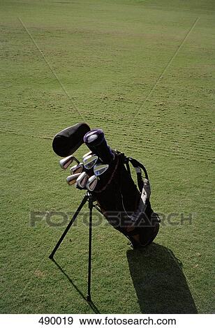 Stock Photo - A golf bag and clubs on a golf course. Fotosearch