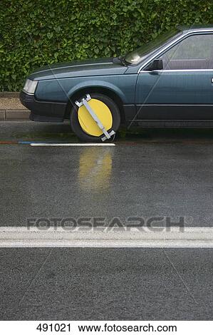 A car with a wheel clamp View Large Photo Image Stock Image - A car with a wheel clamp. Fotosearch