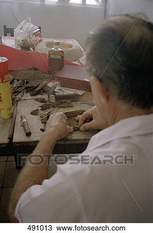 A man a rolling cigar View Large Photo Image Stock Image - A man a rolling cigar. Fotosearch