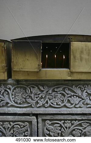 Candles burning in a metal box on an altar View Large Photo Image Stock Image - Candles burning in a metal box on an altar. Fotosearch