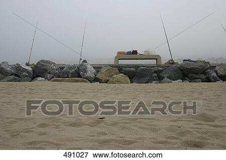 Fishing rods at the edge of the sea View Large Photo Image Stock Photo - Fishing rods at the edge of the sea. Fotosearch