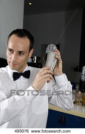A bar tender shaking a cocktail View Large Photo Image Stock Photograph - A bar tender shaking a cocktail. Fotosearch