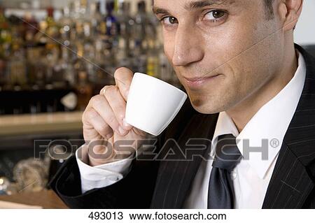 A businessman drinking an espresso View Large Photo Image Stock Image - A businessman drinking an espresso. Fotosearch