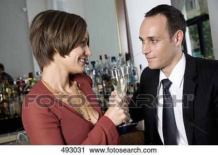 A couple drinking champagne together View Large Photo Image Stock Image - A couple drinking champagne together. Fotosearch
