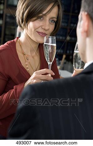 A couple drinking champagne together View Large Photo Image Stock Photo - A couple drinking champagne together. Fotosearch