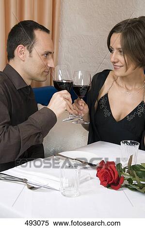 A couple toasting in bar View Large Photo Image Stock Photography - A couple toasting in bar. Fotosearch