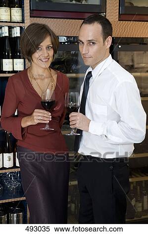Stock Photography - A couple wine tasting. Fotosearch