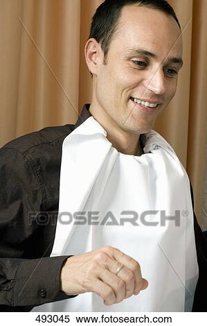 A man with a napkin tucked into his collar View Large Photo Image Stock Photography - A man with a napkin tucked into his collar. Fotosearch