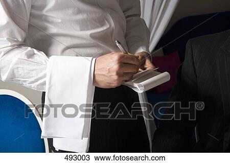 Stock Image - A waiter taking an order. Fotosearch