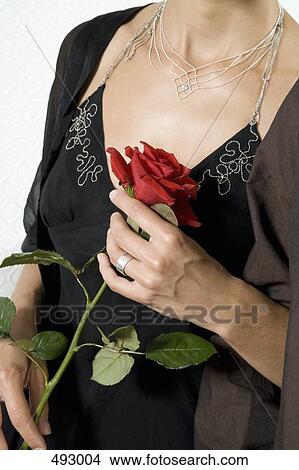 Picture - A woman holding a rose. Fotosearch