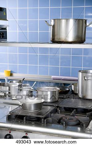 Pans cooking on a stove View Large Photo Image Stock Image - Pans cooking on a stove. Fotosearch