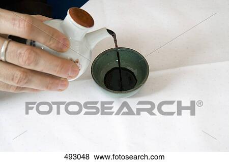 Stock Photo - Pouring soy sauce. Fotosearch