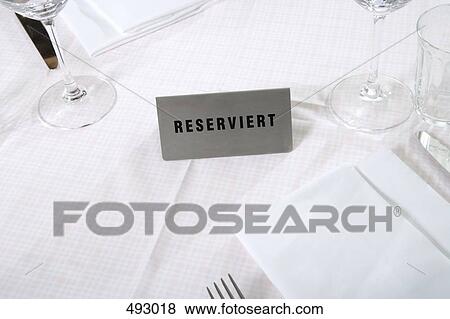 Stock Photo - Reserved sign on a restaurant table. Fotosearch