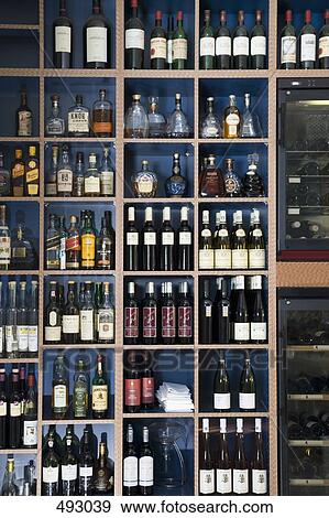 Wine bottles on shelves View Large Photo Image Stock Photo - Wine bottles on shelves. Fotosearch