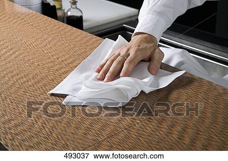 Wiping a kitchen counter View Large Photo Image Stock Photo - Wiping a kitchen counter. Fotosearch