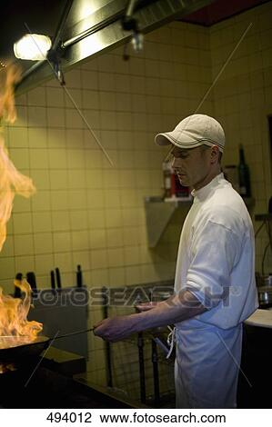 A chef cooking in a kitchen View Large Photo Image Stock Image - A chef cooking in a kitchen. Fotosearch