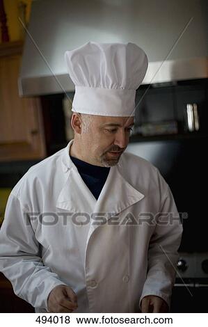A chef standing in a kitchen View Large Photo Image Stock Photo - A chef standing in a kitchen. Fotosearch