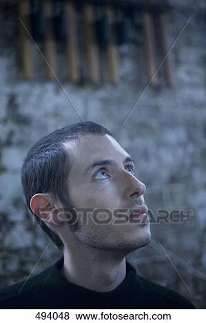 A young man looking up View Large Photo Image Stock Photo - A young man looking up. Fotosearch
