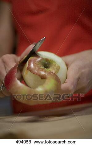 Detail of a woman peeling an apple View Large Photo Image Stock Photo - Detail of a woman peeling an apple. Fotosearch