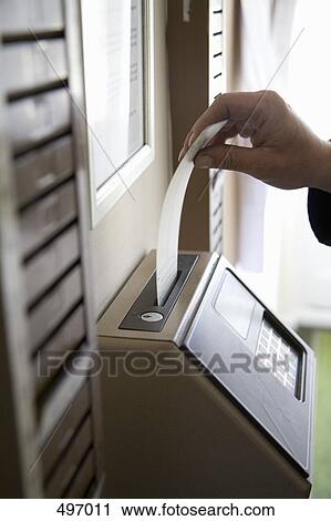 A man inserting a time card into a time clock View Large Photo Image Stock Image - A man inserting a time card into a time clock. Fotosearch