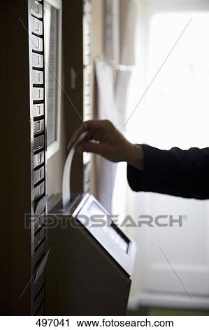A man inserting a time card into a time clock View Large Photo Image Stock Image - A man inserting a time card into a time clock. Fotosearch