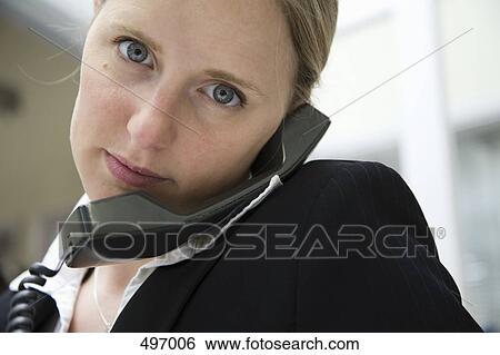 A woman using a landline telephone View Large Photo Image Stock Photograph - A woman using a landline telephone. Fotosearch