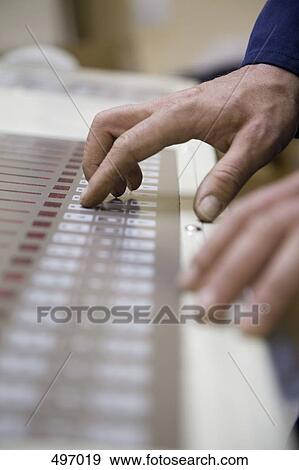 Detail of a man operating a printing machine in a factory View Large Photo Image Stock Photo - Detail of a man operating a printing machine in a factory. Fotosearch