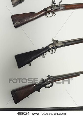 A collection of rifles on a wall View Large Photo Image Picture - A collection of rifles on a wall. Fotosearch