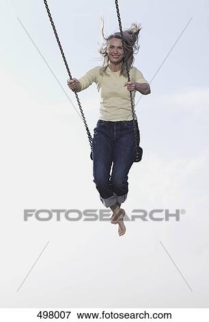 A mature woman on a swing View Large Photo Image Stock Photo - A mature woman on a swing. Fotosearch