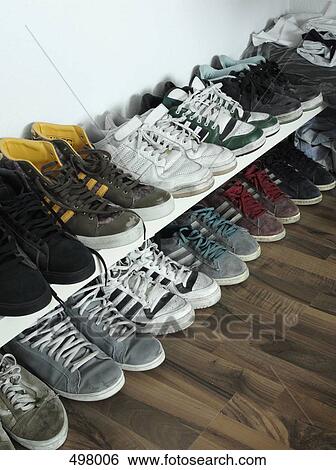 Rows of trainers against a wall View Large Photo Image Stock Photograph - Rows of trainers against a wall. Fotosearch