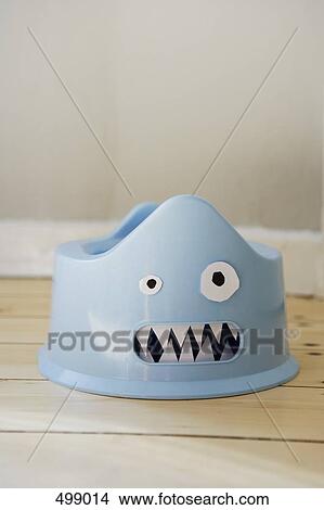 A plastic potty with a cardboard face View Large Photo Image Picture - A plastic potty with a cardboard face. Fotosearch