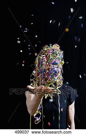 A woman covered in streamers and throwing confetti View Large Photo Image Stock Photo - A woman covered in streamers and throwing confetti. Fotosearch