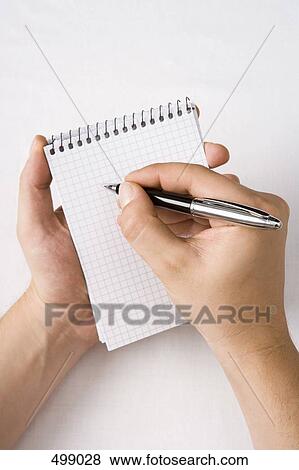 Detail of a man holding a notepad and pen View Large Photo Image Stock Photo - Detail of a man holding a notepad and pen. Fotosearch