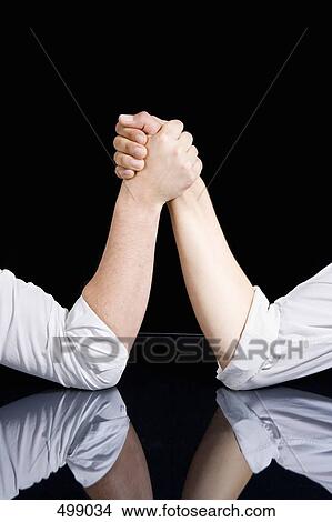 Detail of two men preparing to arm wrestle View Large Photo Image Picture - Detail of two men preparing to arm wrestle. Fotosearch