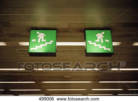 Illuminated emergency exit signs on a ceiling View Large Photo Image Stock Photograph - Illuminated emergency exit signs on a ceiling. Fotosearch